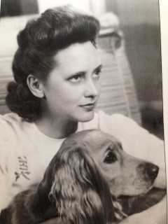 Young Betty McIntosh with a dog during WWII